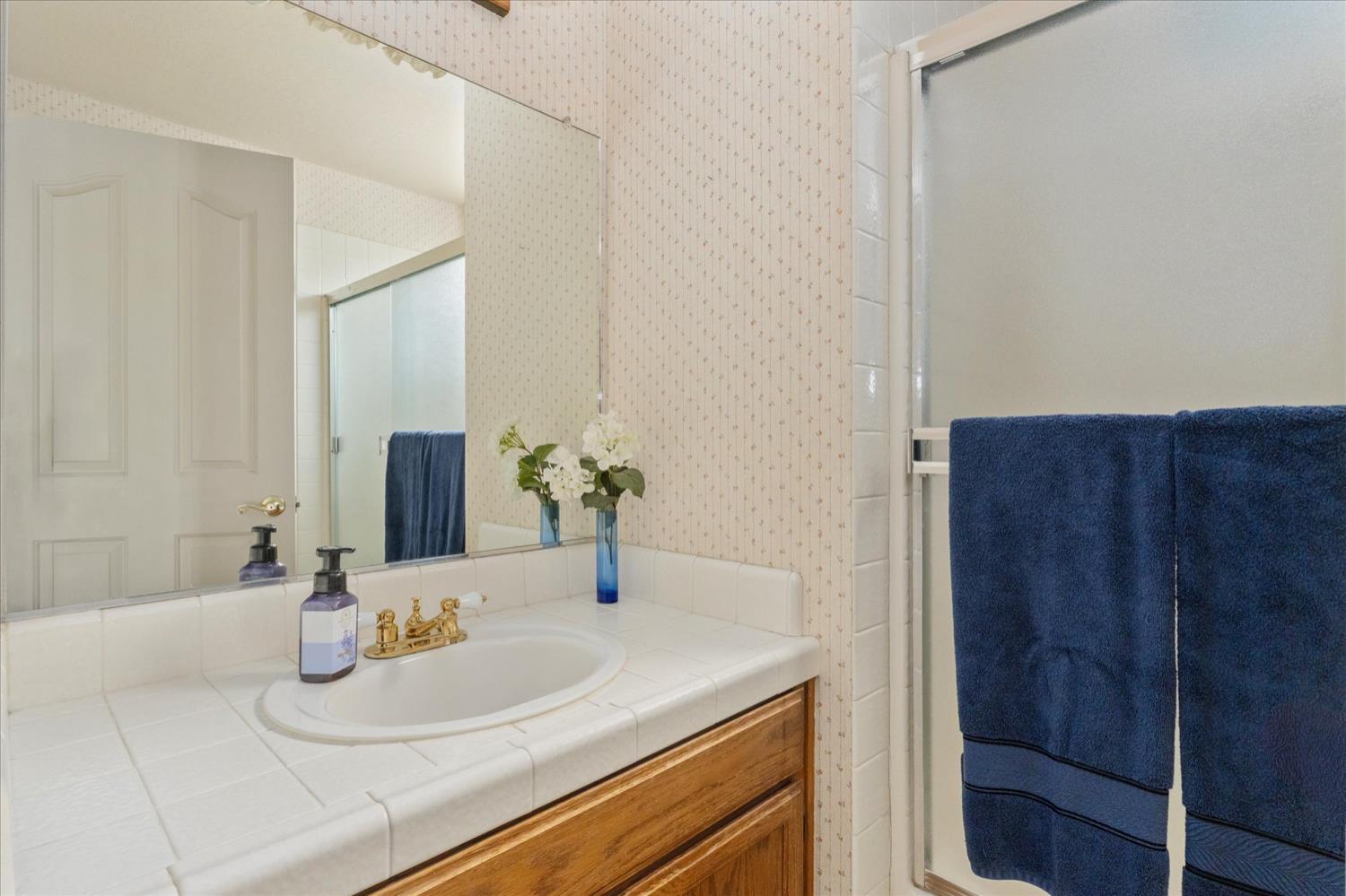596 Sugarbush Lane Murphys, CA 95247 - Photo 43 of 48 a bathroom with a sink and a mirror