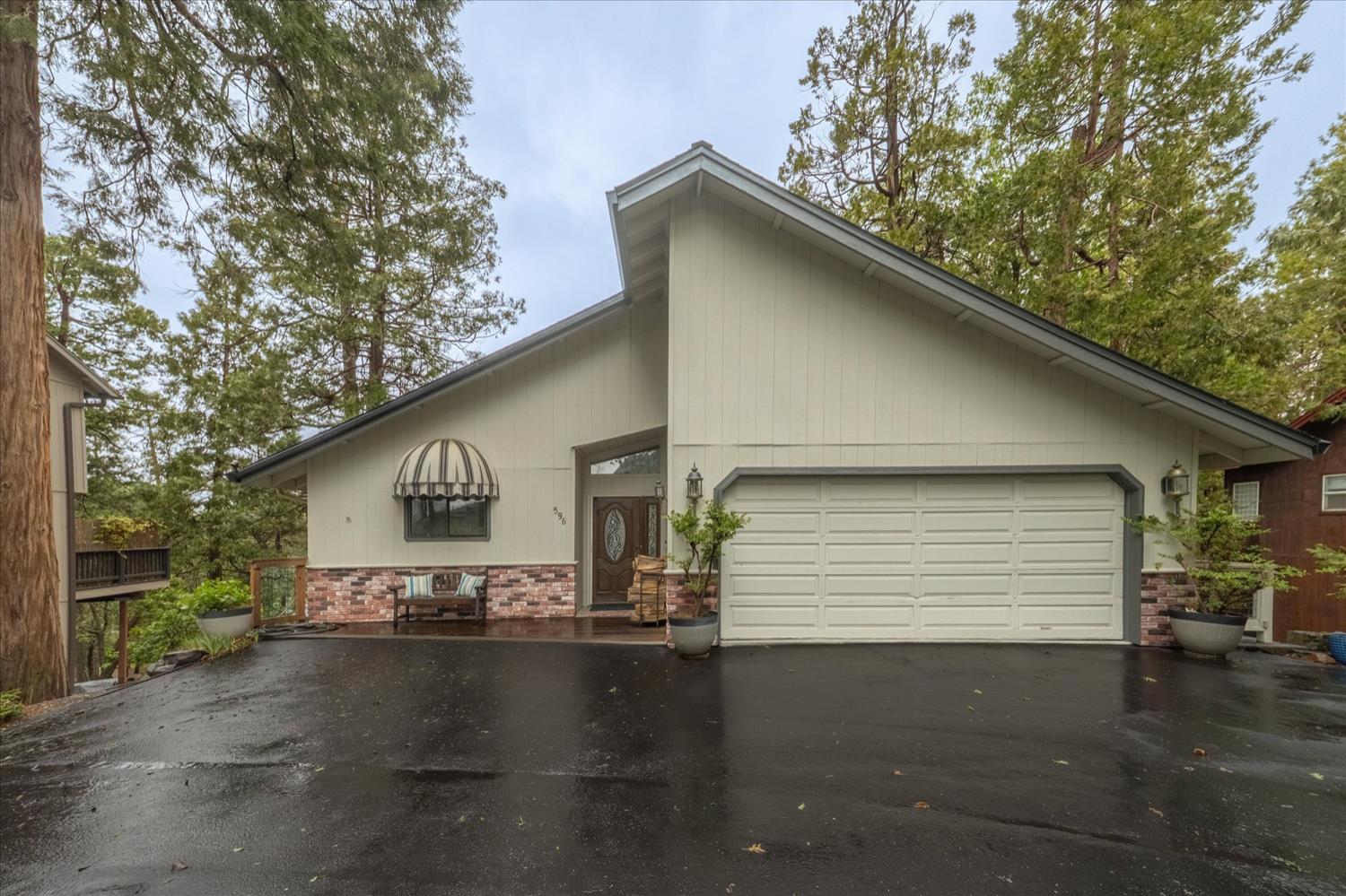 596 Sugarbush Lane Murphys, CA 95247 - Photo 8 of 48 a front view of a house with a yard and garage