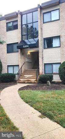 a view of front door of house with a yard