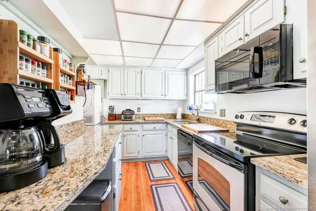 a kitchen with stainless steel appliances granite countertop a stove and a sink