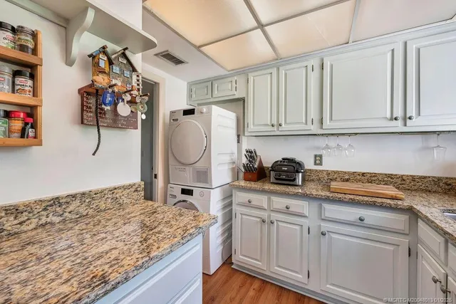 a kitchen with white cabinets and sink