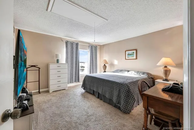 a bedroom with a bed and a desk