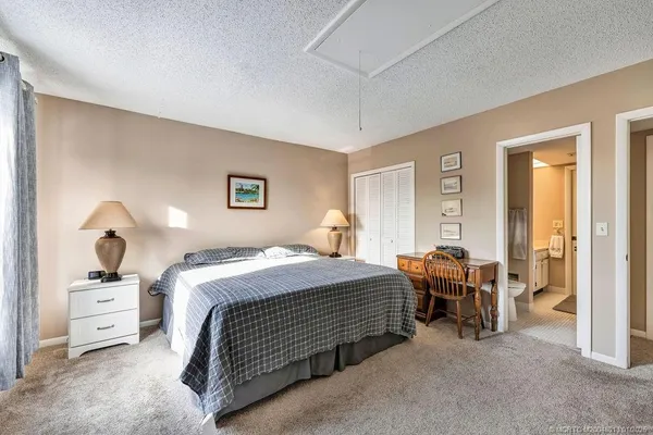 a bedroom with bed and a chandelier