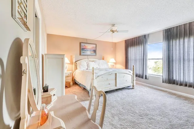 a spacious bedroom with a bed and a window