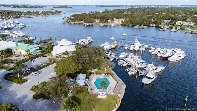 an aerial view of a house with yard swimming pool and ocean view