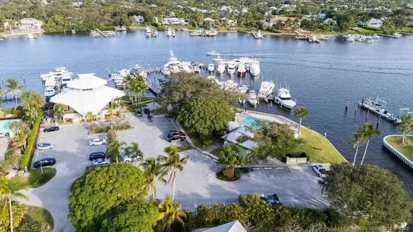 an aerial view of a house with a yard and lake view