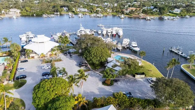 an aerial view of a house with a yard and lake view