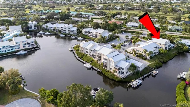 an aerial view of a house with outdoor space and lake view