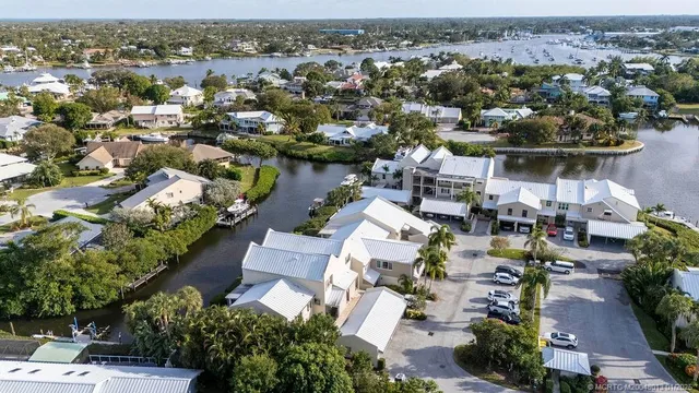 an aerial view of a houses with a lake view