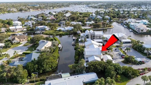 an aerial view of residential houses with outdoor space and swimming pool