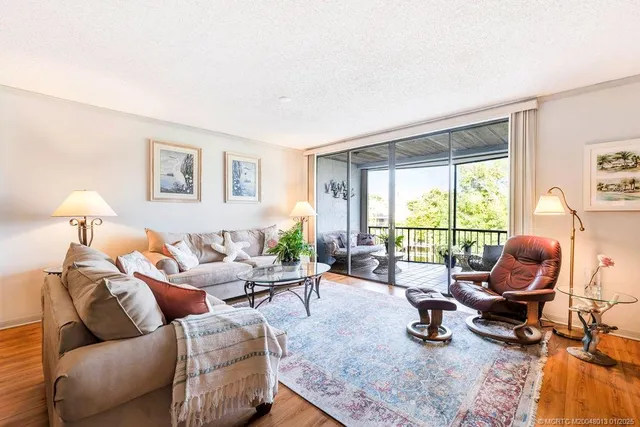 a living room with furniture fireplace and a large window