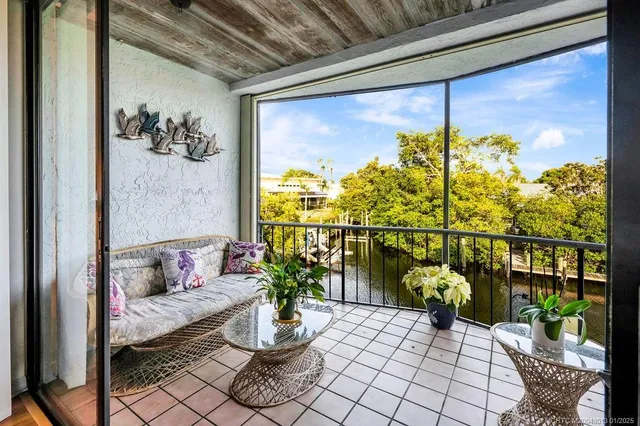a view of a porch with furniture and a potted plant