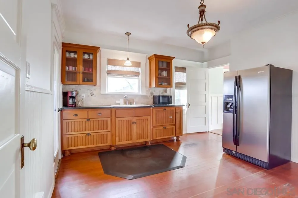 745 Main Street Ramona, CA 92065 - Photo 14 of 40 a kitchen with granite countertop a refrigerator a stove a sink and dishwasher with wooden floor