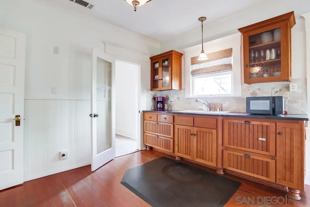 745 Main Street Ramona, CA 92065 - Photo 15 of 40 a kitchen with granite countertop wooden cabinets a sink and dishwasher