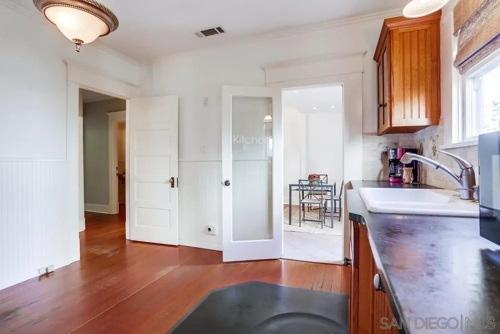 745 Main Street Ramona, CA 92065 - Photo 16 of 40 a view of a kitchen cabinets and wooden floor