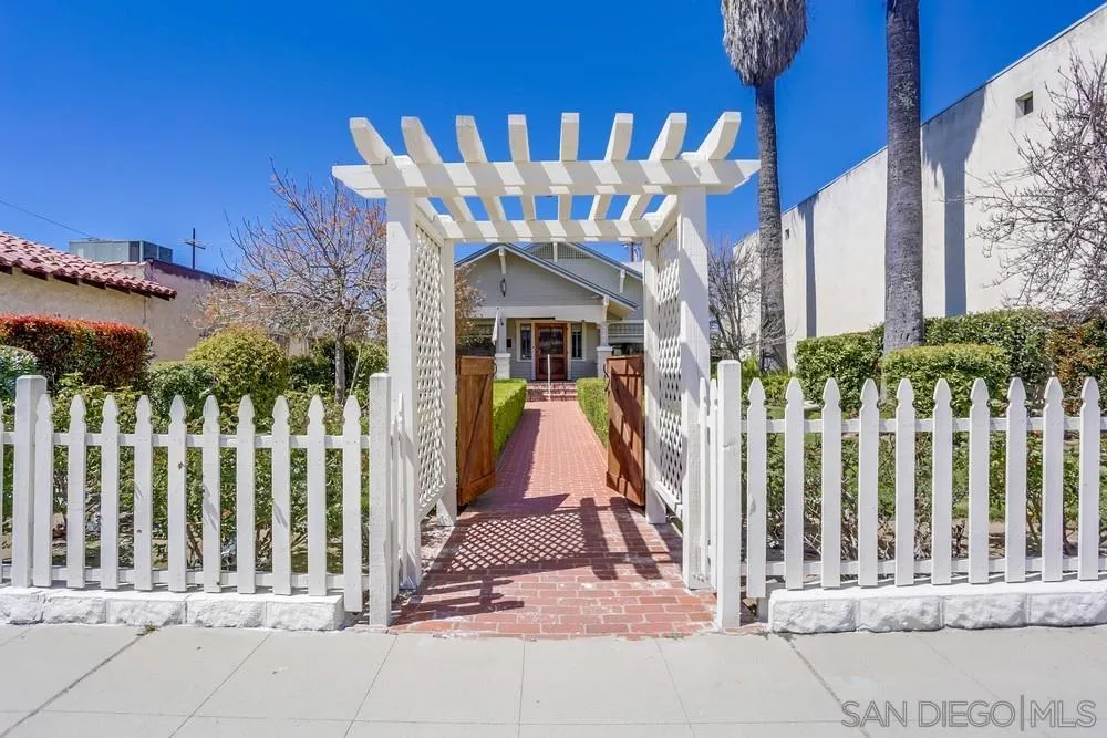 745 Main Street Ramona, CA 92065 - Photo 2 of 40 a view of a brick house with large windows and a small yard