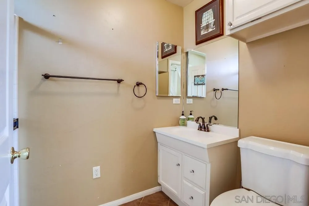 745 Main Street Ramona, CA 92065 - Photo 31 of 40 a bathroom with a toilet sink and mirror