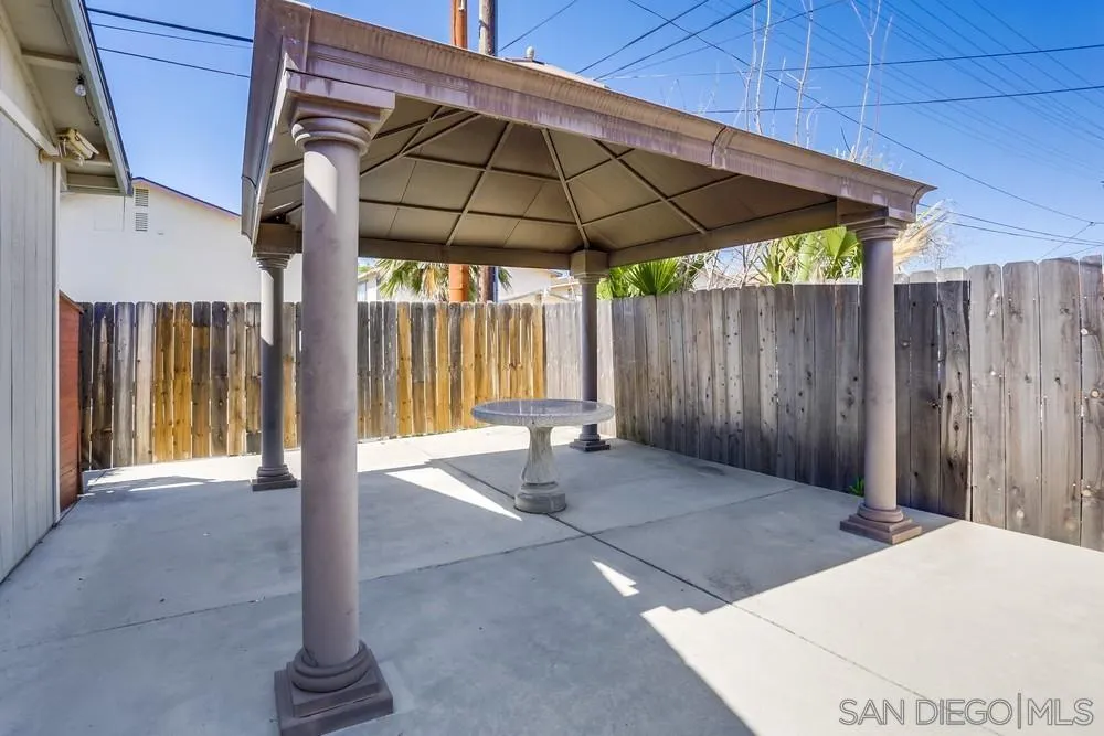 745 Main Street Ramona, CA 92065 - Photo 39 of 40 a patio with a table and chairs under an umbrella