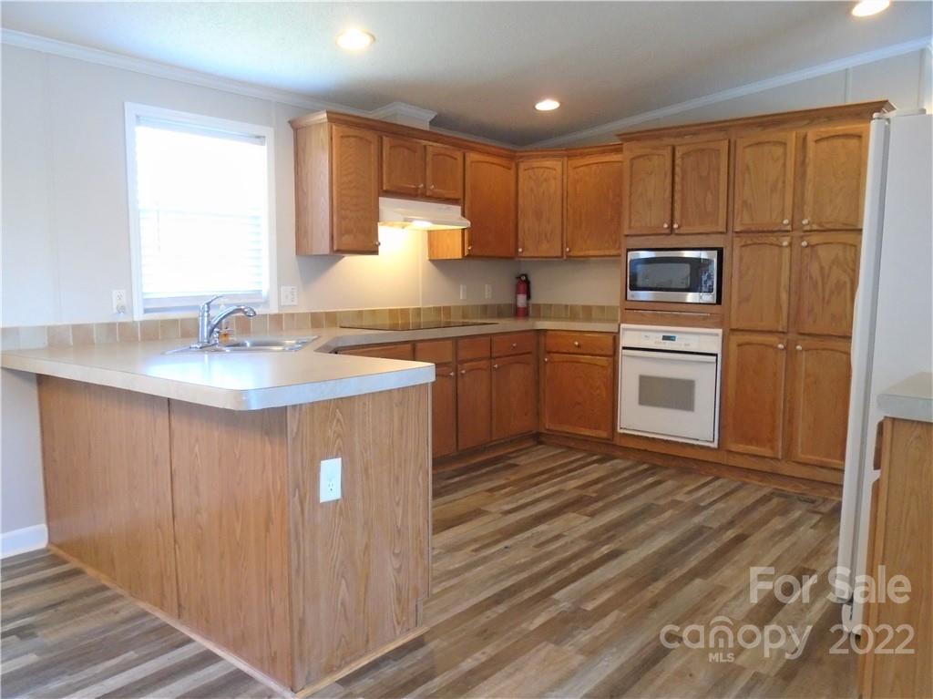 4730 Stagecoach Road Catawba, NC 28609 - Photo 11 of 37 a kitchen with stainless steel appliances granite countertop a sink stove refrigerator and cabinets
