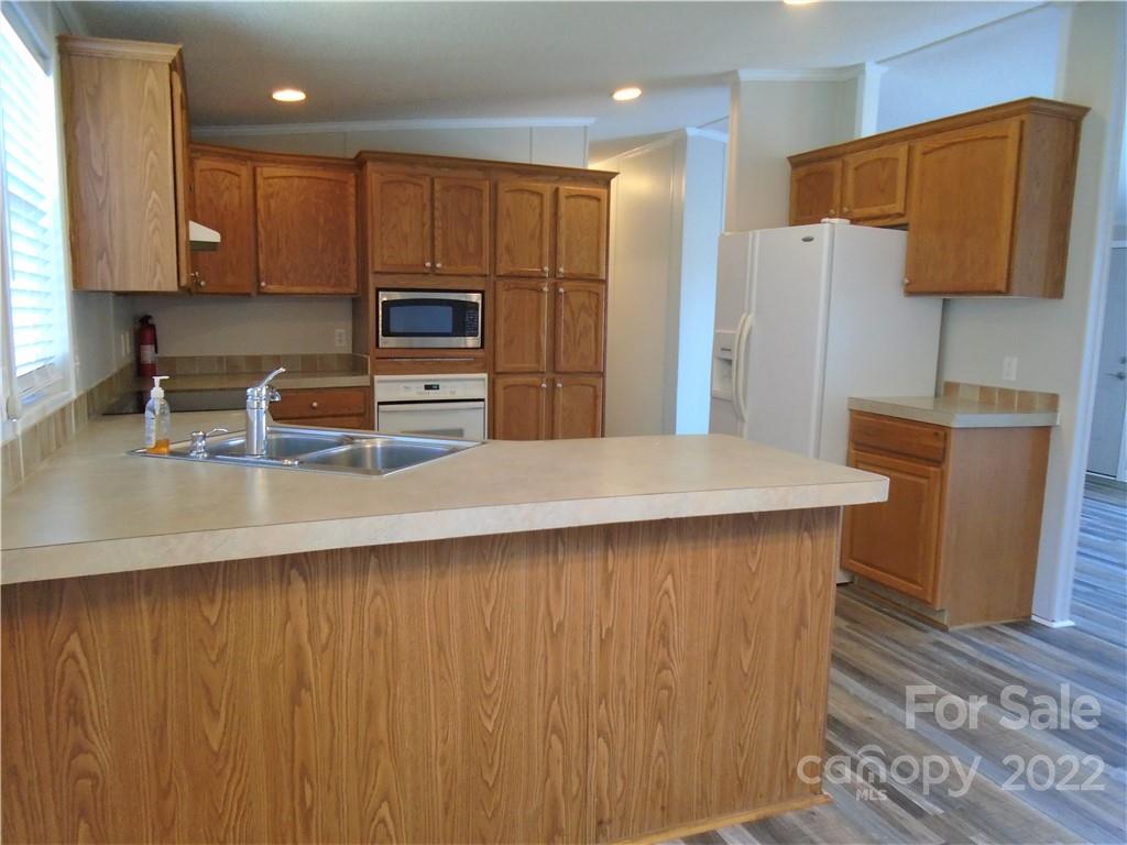 4730 Stagecoach Road Catawba, NC 28609 - Photo 12 of 37 a kitchen with stainless steel appliances a refrigerator and a stove top oven