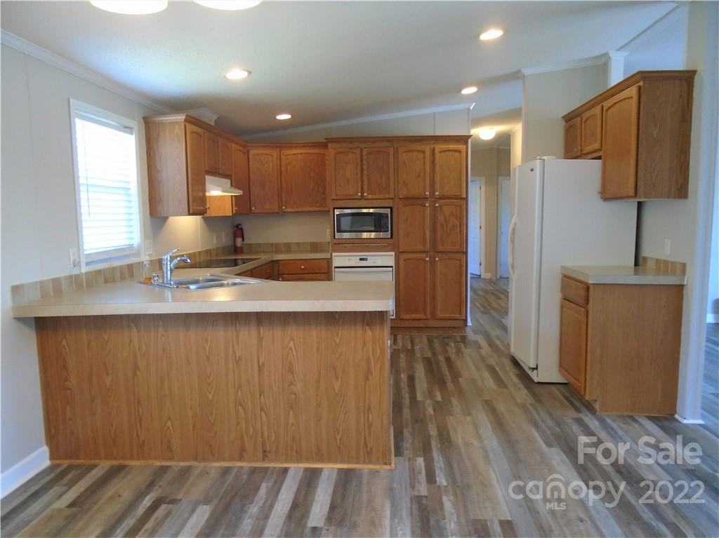4730 Stagecoach Road Catawba, NC 28609 - Photo 10 of 37 a kitchen with kitchen island a counter top space a sink stainless steel appliances and cabinets