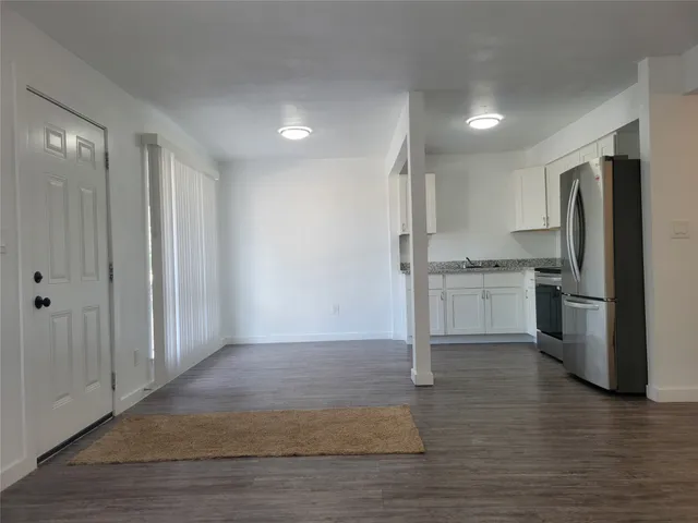 a kitchen with stainless steel appliances granite countertop a refrigerator and a stove top oven