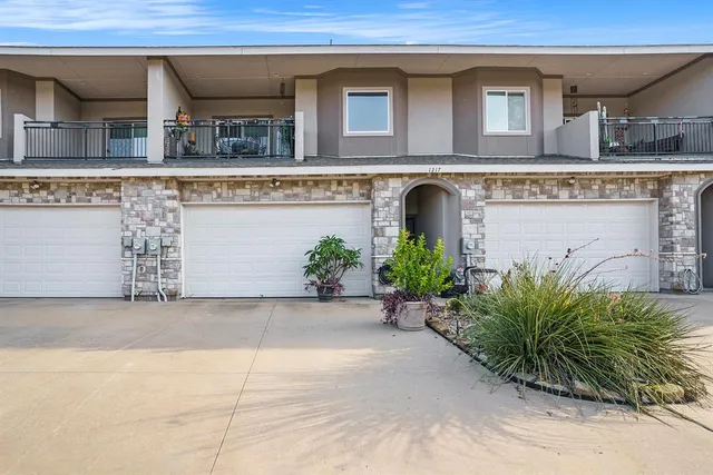 a view of a building with potted plants