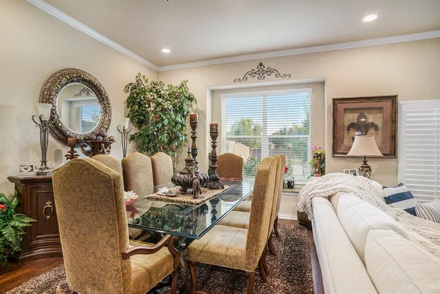a living room with furniture a large window and wooden floor