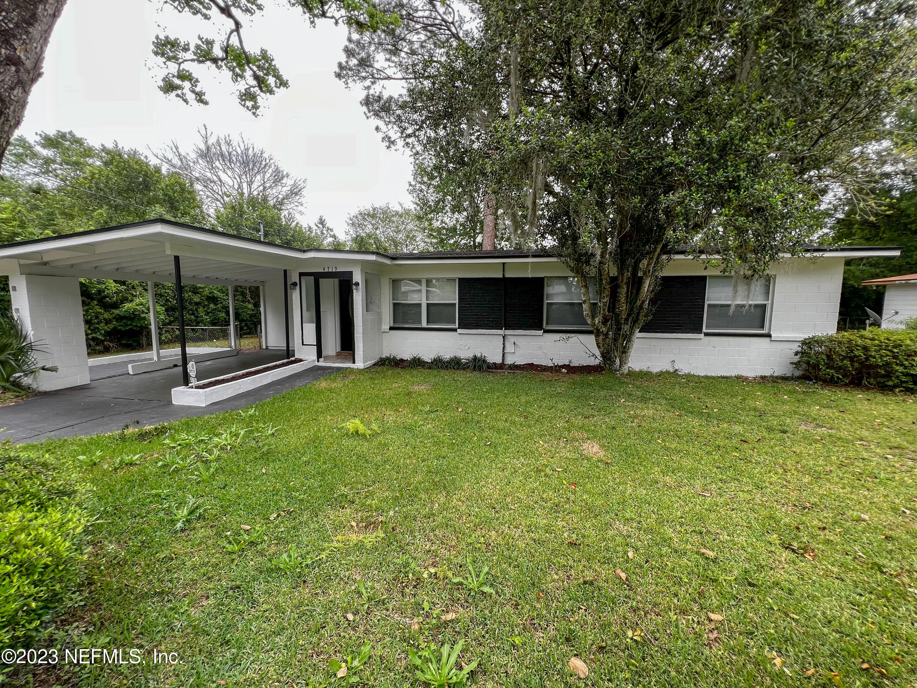 4719 Andromeda Road Jacksonville, FL 32210 - Photo 1 of 28 a front view of house with yard and green space
