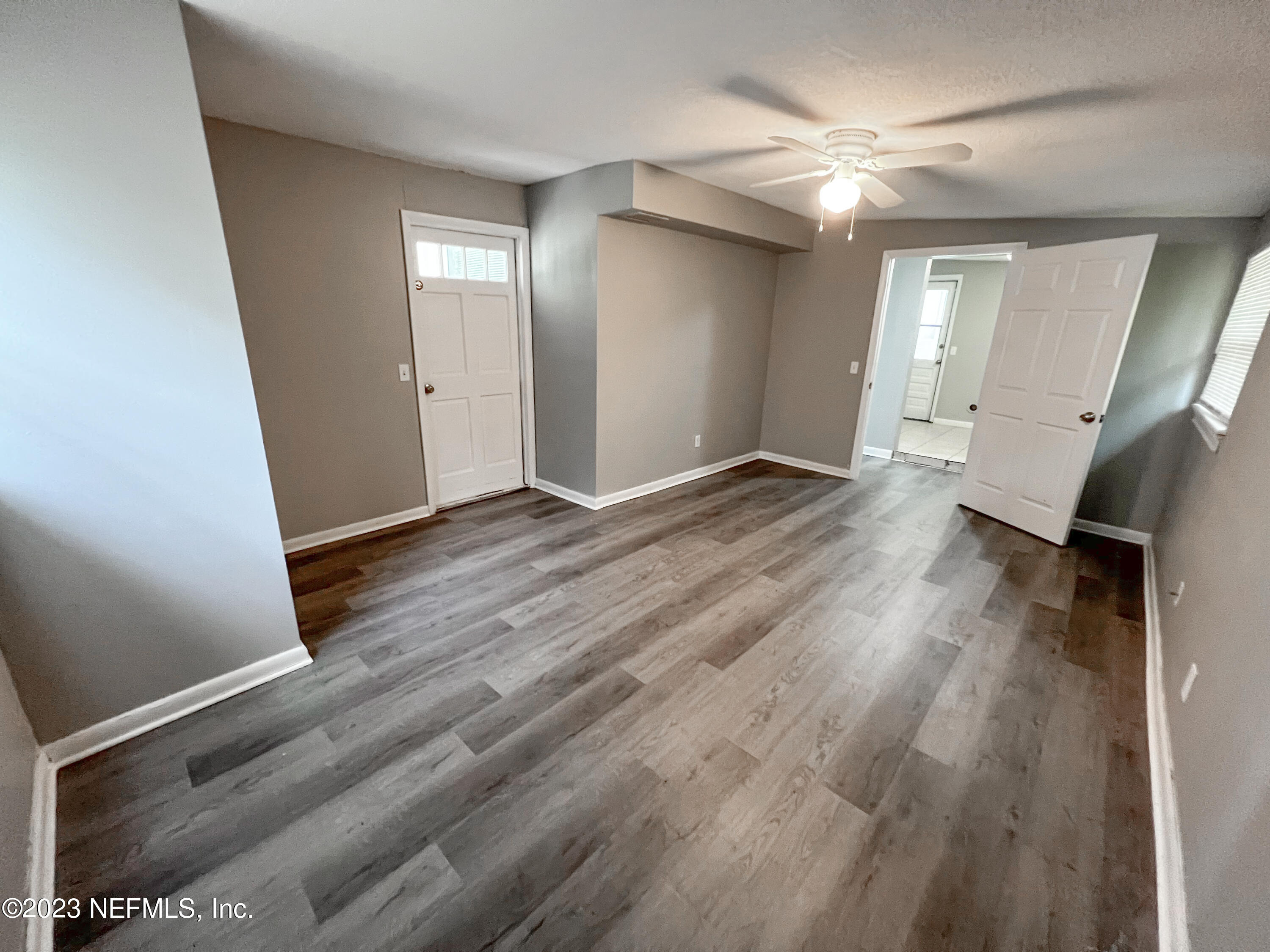 4719 Andromeda Road Jacksonville, FL 32210 - Photo 25 of 28 a view of an empty room with wooden floor and a window