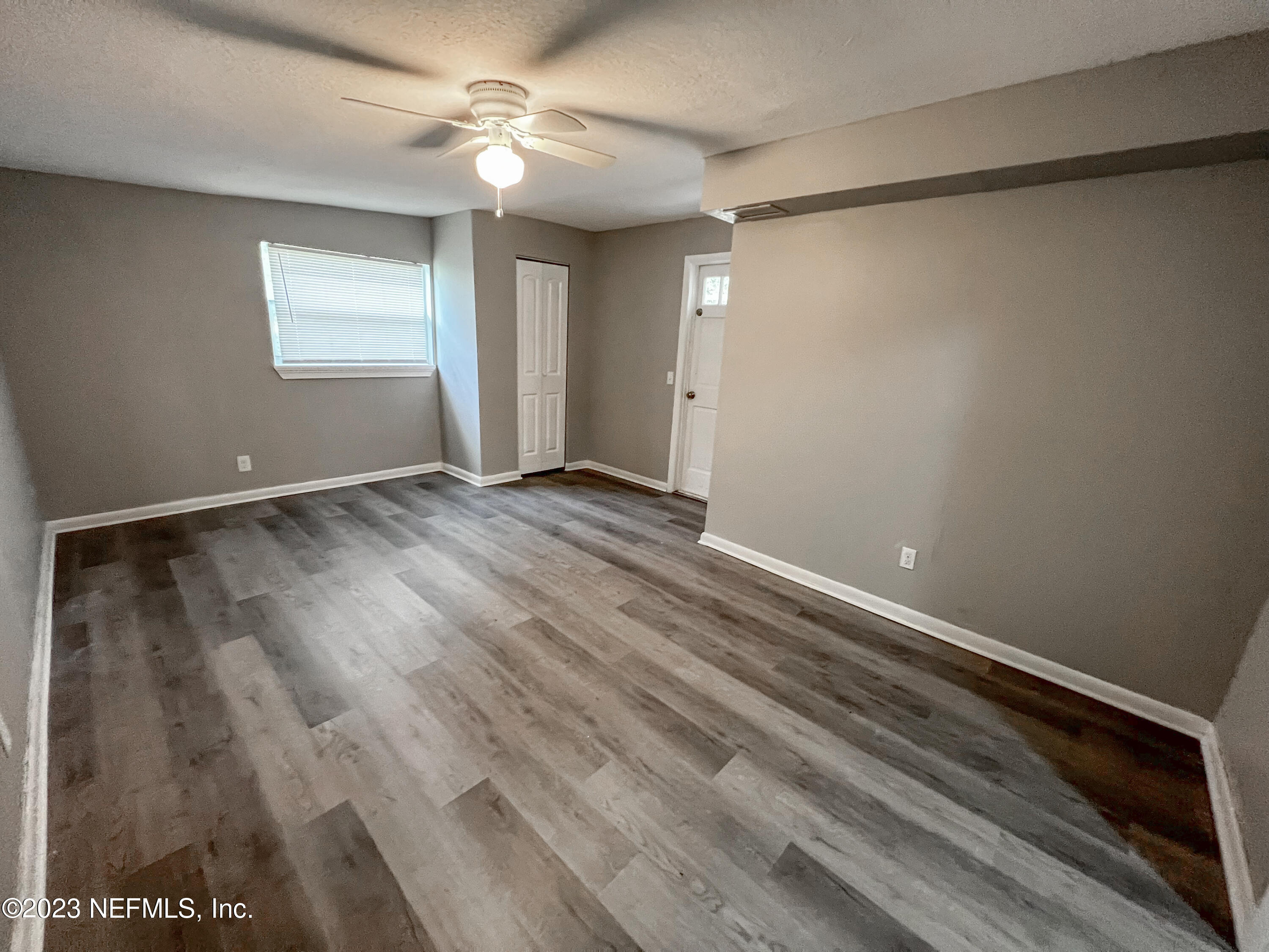 4719 Andromeda Road Jacksonville, FL 32210 - Photo 28 of 28 wooden floor in an empty room with a window