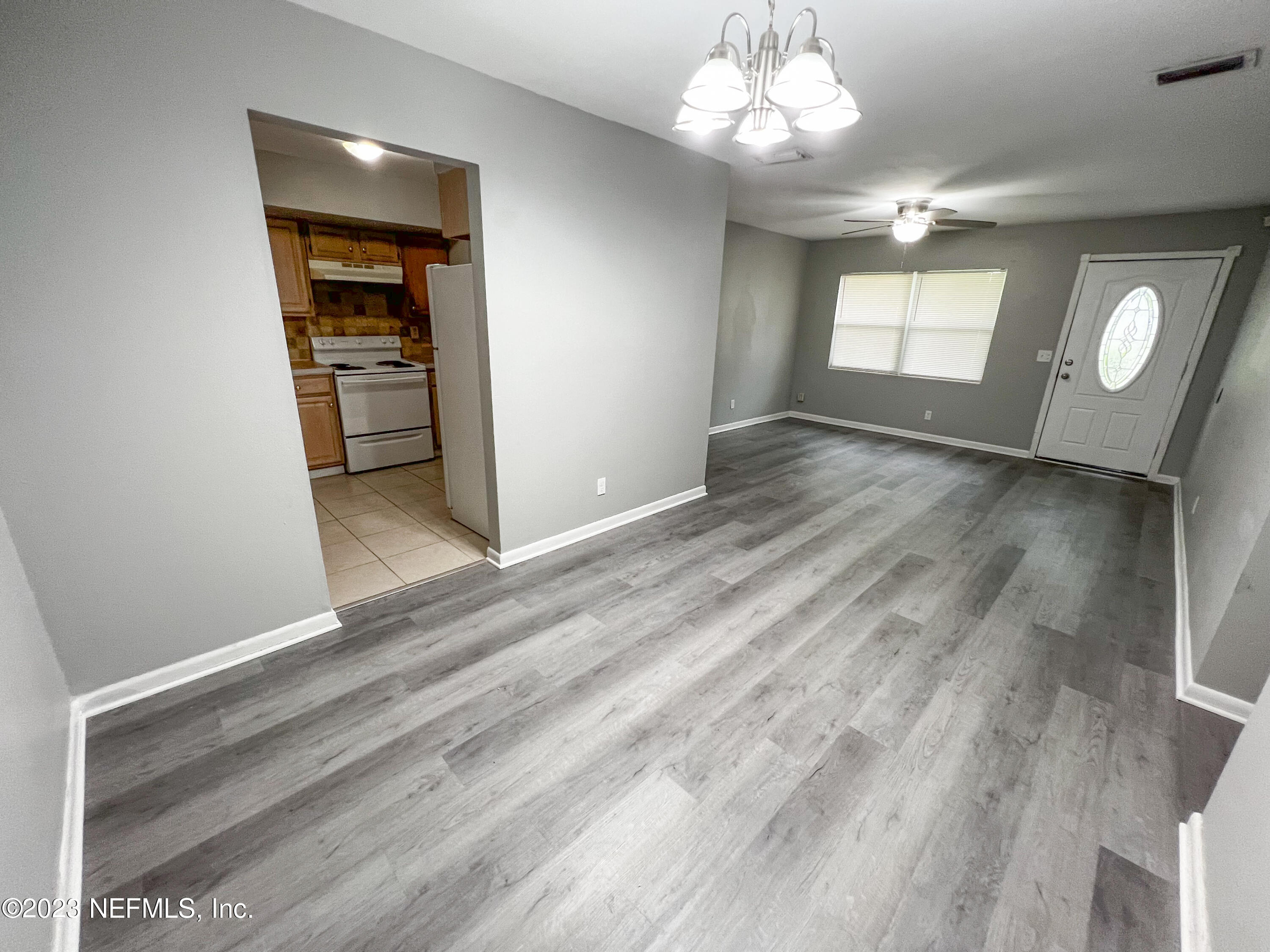4719 Andromeda Road Jacksonville, FL 32210 - Photo 7 of 28 wooden floor in an empty room with a window