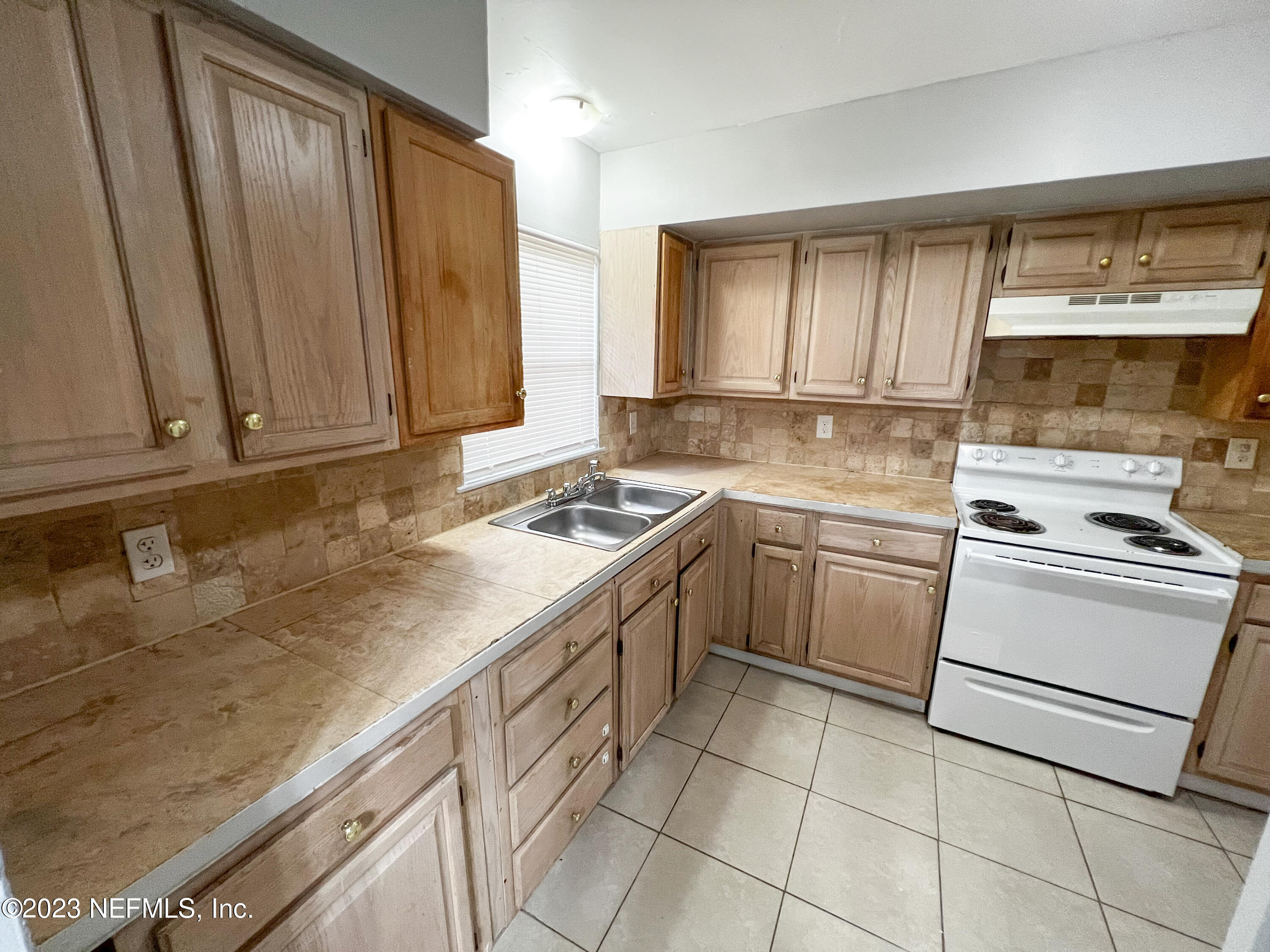 4719 Andromeda Road Jacksonville, FL 32210 - Photo 8 of 28 a kitchen with a sink stove and cabinets