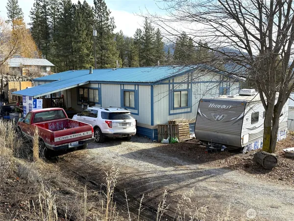 a couple of cars parked in front of a house