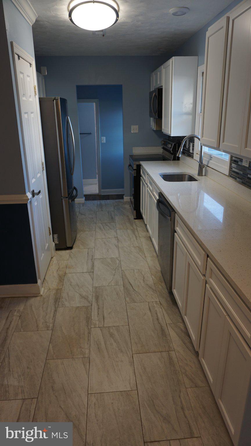 5854 Deale Churchton Road Deale, MD 20751 - Photo 13 of 57 Modern kitchen with sleek finishes.