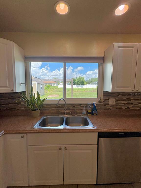 2755 Greendale Road North Port, FL 34287 - Photo 8 of 43 a kitchen with a sink and large window