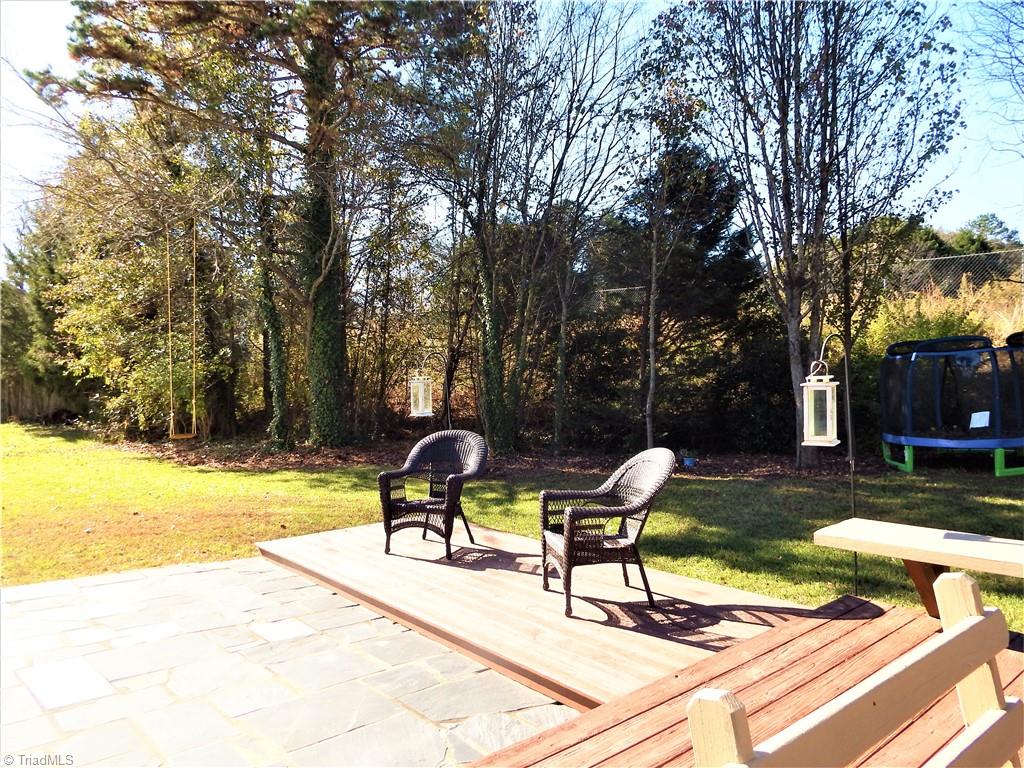 1730 Spring Path Trail Clemmons, NC 27012 - Photo 20 of 21 Multi Layer Deck and Stone Patio Offering Great Exterior Space!