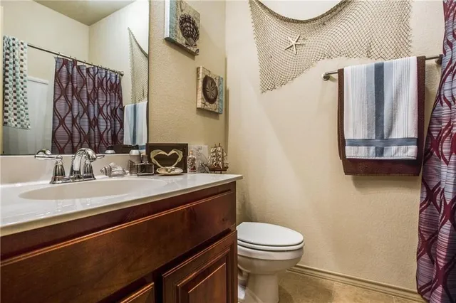 a bathroom with a sink a toilet and mirror
