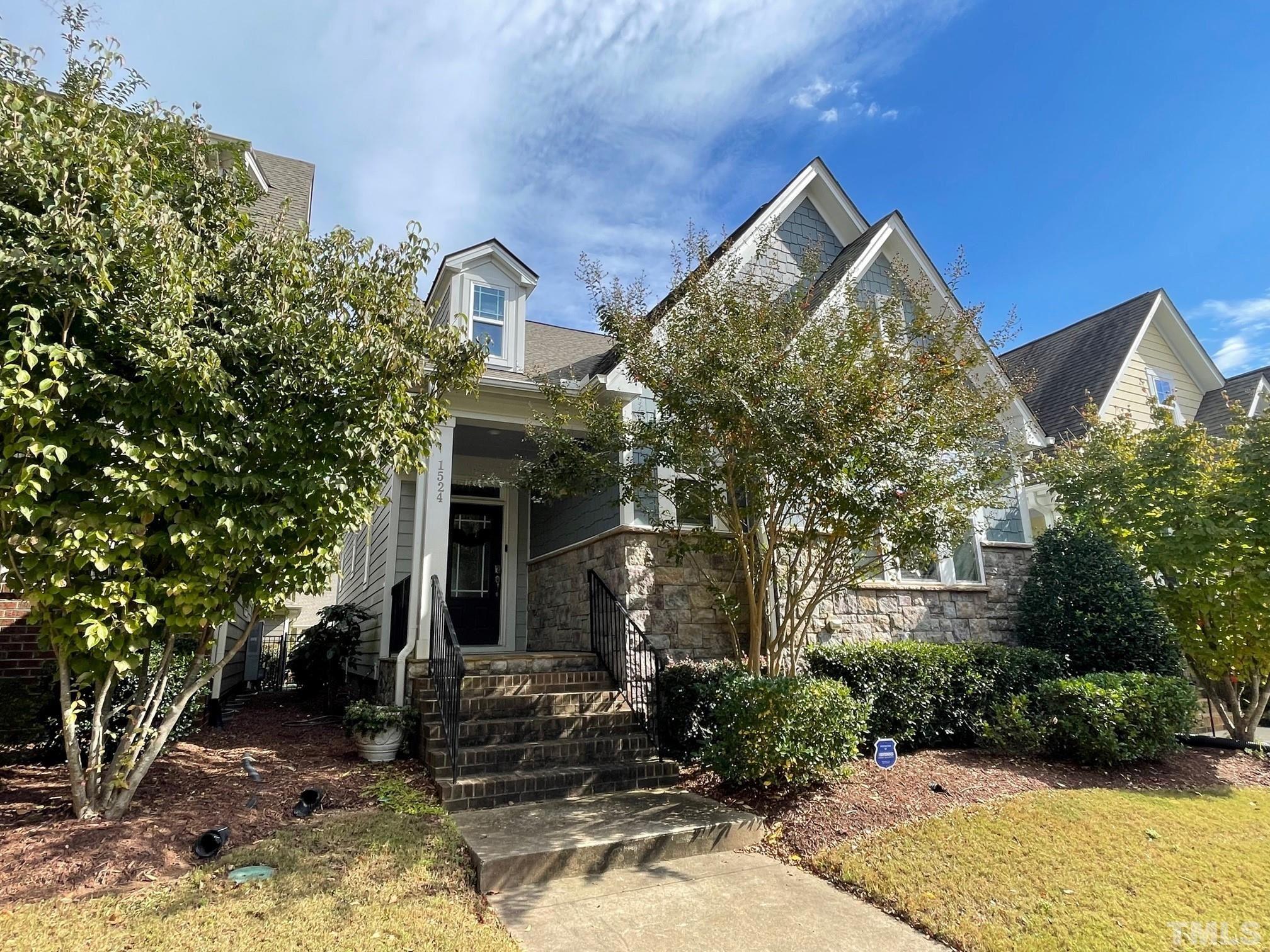 1524 Rodessa Run Raleigh, NC 27607 - Photo 1 of 25 a view of a house with brick walls and potted plants