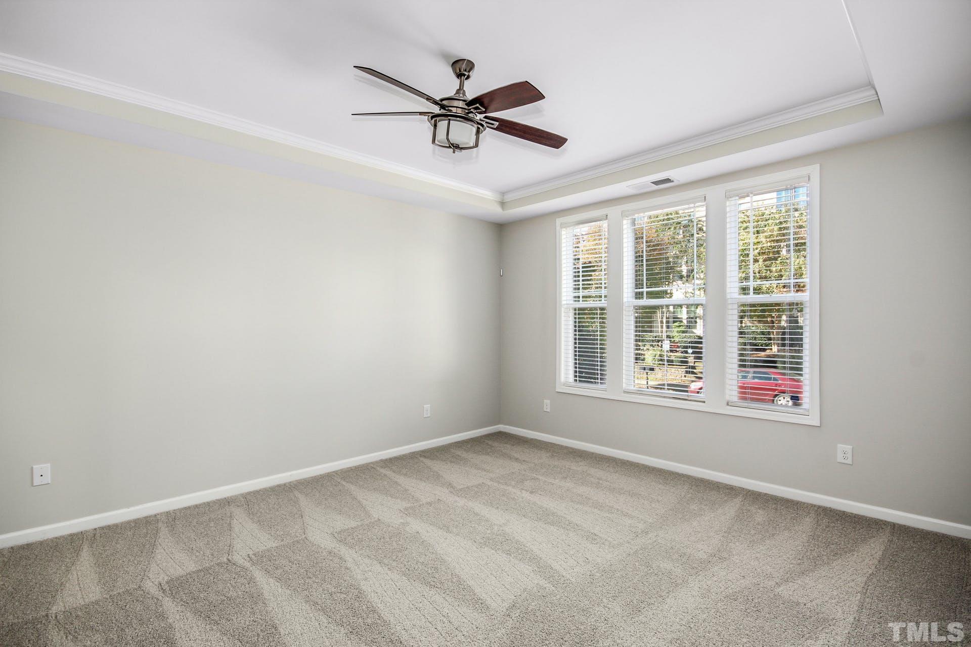 1524 Rodessa Run Raleigh, NC 27607 - Photo 11 of 25 an empty room with ceiling fan and windows