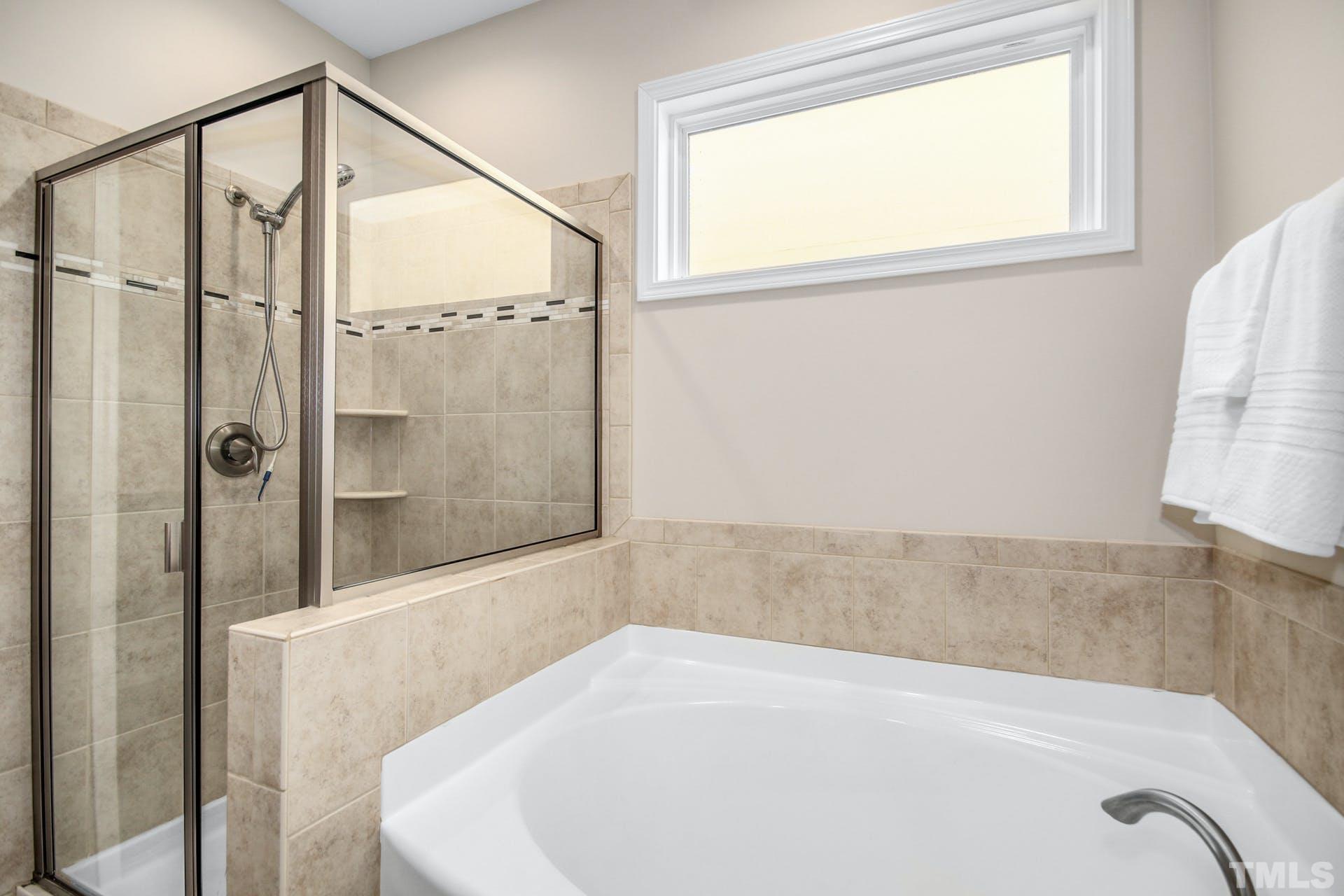 1524 Rodessa Run Raleigh, NC 27607 - Photo 14 of 25 a bathroom with a bathtub and a shower