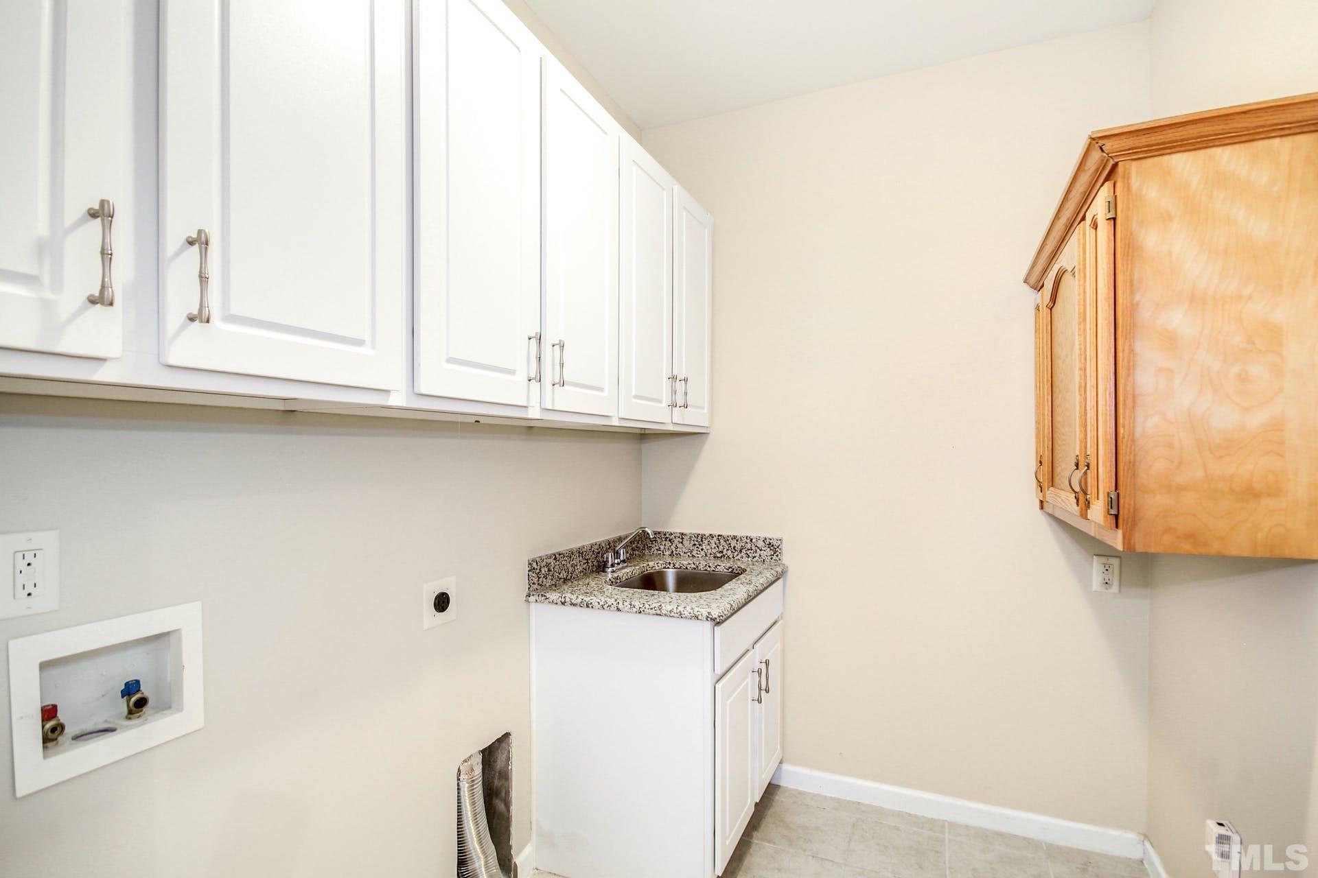 1524 Rodessa Run Raleigh, NC 27607 - Photo 16 of 25 a kitchen with a white cabinets and a stove