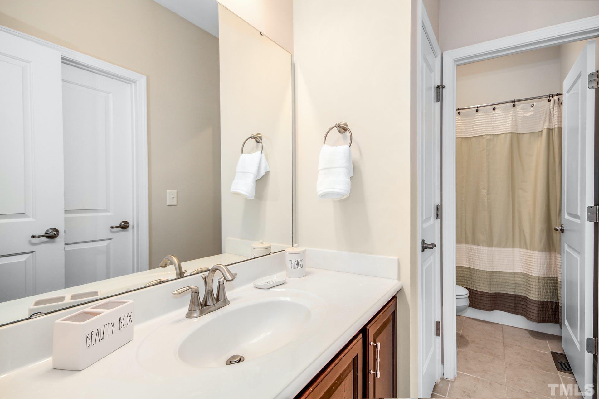 1524 Rodessa Run Raleigh, NC 27607 - Photo 19 of 25 a bathroom with a double vanity sink mirror and shower