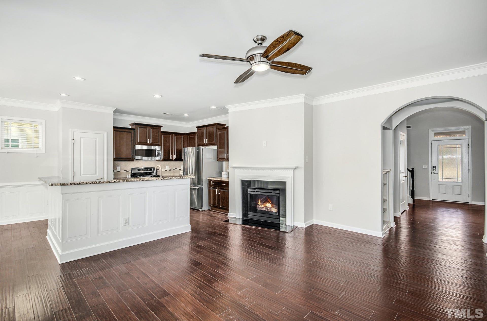 1524 Rodessa Run Raleigh, NC 27607 - Photo 5 of 25 a living room with stainless steel appliances kitchen island with wooden floors