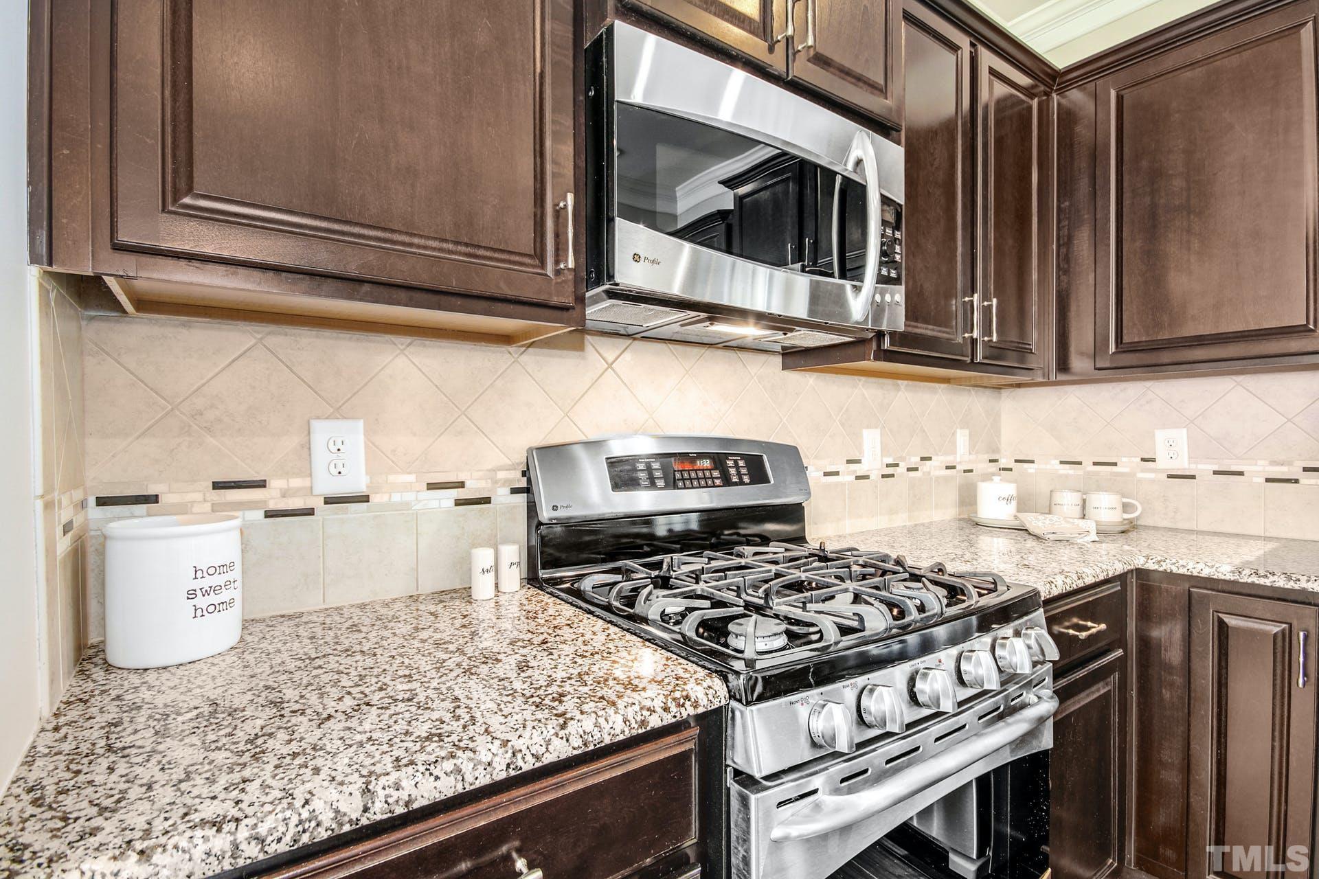 1524 Rodessa Run Raleigh, NC 27607 - Photo 10 of 25 a kitchen with a stove and a microwave