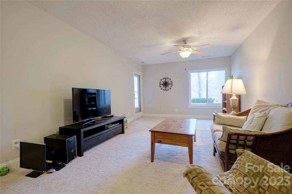 83 Ridgeport Road Lake Wylie, SC 29710 - Photo 33 of 48 a living room with furniture a flat screen tv and a window