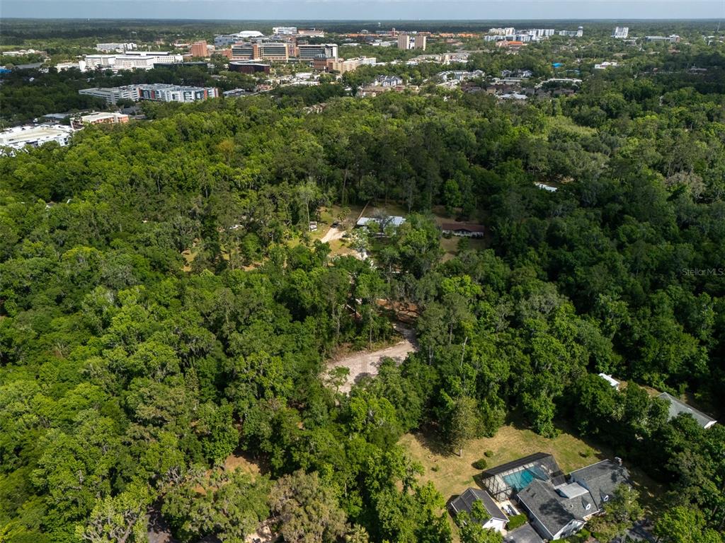 983 Southwest 25th Place Gainesville, FL 32608 - Photo 11 of 13 an aerial view of residential houses with outdoor space and trees