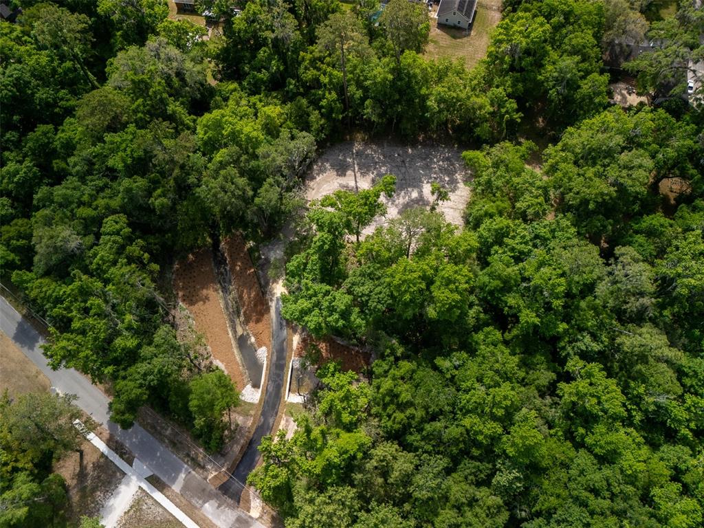 983 Southwest 25th Place Gainesville, FL 32608 - Photo 4 of 13 an aerial view of residential house with outdoor space and trees all around