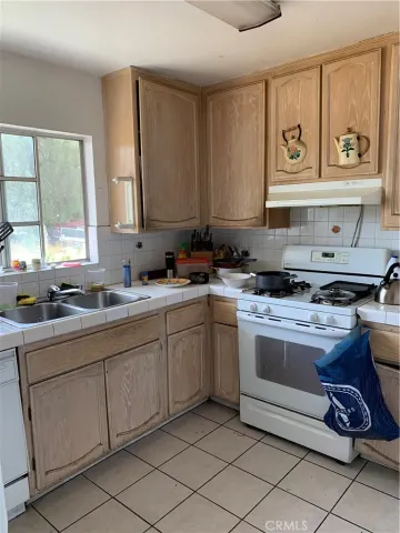 a kitchen with stainless steel appliances granite countertop a sink and cabinets