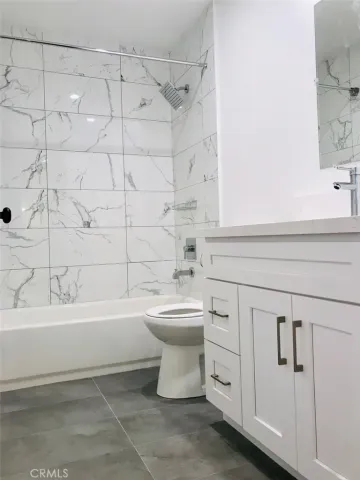 a bathroom with a sink a toilet and bathtub